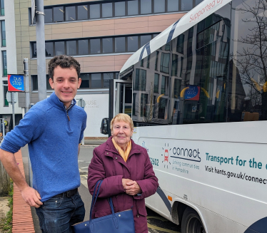 Sam disembarks from the #44 bus with a local resident